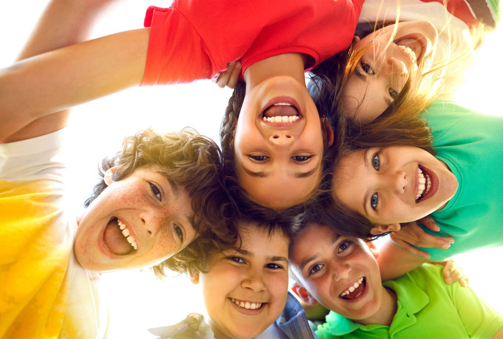 A group of children are smiling for the camera.